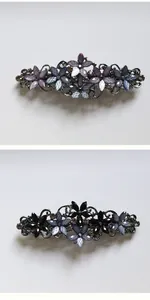 Detailed close-up of retro floral hair clips with matte petals and crystal rhinestones
