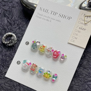Detail of 3D Santa Claus and Christmas tree decorations on handmade press-on nails