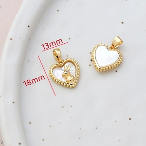 Close-up of 14k gold plated heart pendant with white mother of pearl and rabbit detail