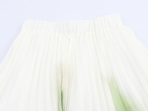 Detailed view of elastic waistband and pleated texture on a white chiffon bohemian skirt