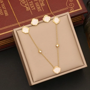 Elegant gold necklace and earring set with white shell petals and zircon accents