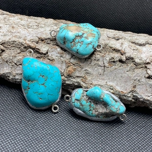 Three irregular blue turquoise pendants with silver metal frames and double connectors