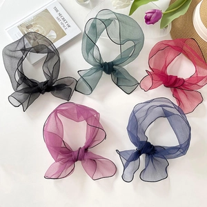 Five assorted organza bow hair scarves in various colors on a stylish lifestyle background