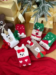 Close-up of fluffy Christmas socks set with 3D cute cartoon reindeer and Santa patterns