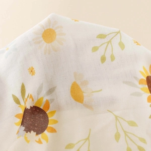 Detail of sunflower and daisy print on breathable cotton gauze baby blanket fabric