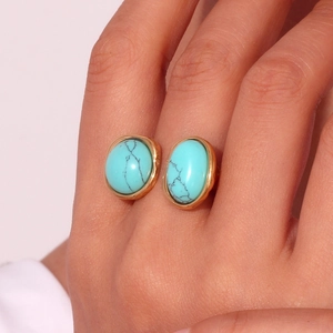 Close-up of vintage 18K gold-plated irregular earrings set with natural turquoise stone