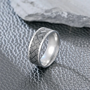 Macro detail of titanium steel ring with punk style geometric texture on leather