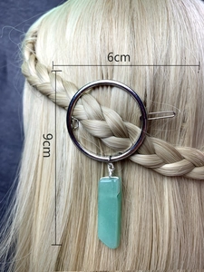 Detail view of round silver hair clip with green gemstone pendant and 6x9cm dimensions