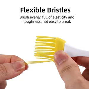 Flexible yellow silicone basting brush with white handle for BBQ and baking
