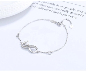Macro detail of S925 sterling silver infinity heart bracelet with cubic zirconia accents