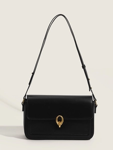 Minimalist black leather shoulder bag with elegant gold oval buckle and glossy finish