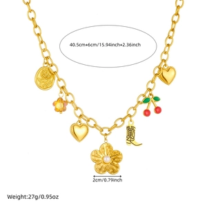 Gold chain necklace with floral, cherry, and boot pendants on a clean white background