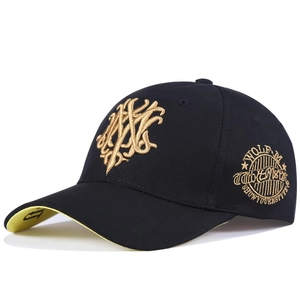 Detail of black baseball cap showing gold logo embroidery and yellow brim underside