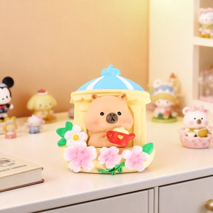 Detail of cute resin capybara magnet with teapot and cherry blossom in European window