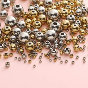 Bulk stainless steel beads in gold and silver colors with various sizes for DIY jewelry making