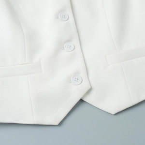 Detail of white suit vest with three buttons and high-density twill fabric texture