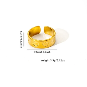 Detail view of gold heart embossed ring with 0.7cm width and 1.9cm diameter specs