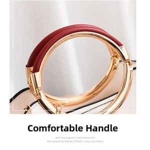 Detail of the semi-circular golden metal handle wrapped in premium red leather on a white bag