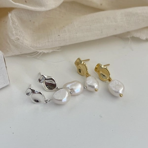 Detail of baroque freshwater pearls on 925 sterling silver studs in gold and silver