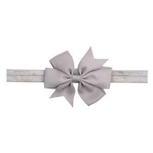 Detail of gray grosgrain ribbon bow on a soft elastic headband for infants and babies