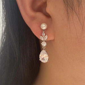 Elegant leaf zircon drop earrings with white pearls and pear-shaped crystals on model