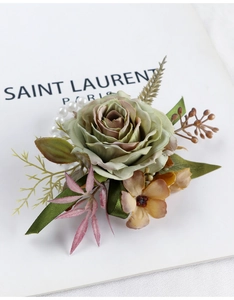 Detail of artificial green rose boutonniere with elegant white faux pearl chain decoration