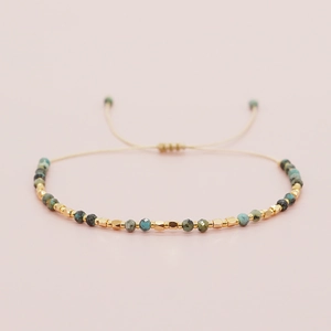 Bohemian handmade string bracelet with turquoise stone beads and gold metal spacers