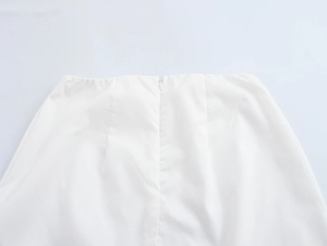 Detail of invisible back zipper on white resort skirt with palm tree embroidery