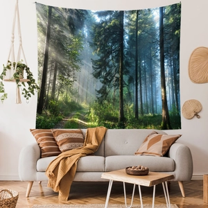 Close-up of a forest landscape tapestry above a gray sofa in a cozy, sunlit living room
