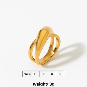 Macro detail of glossy golden crossover geometric ring in stainless steel material