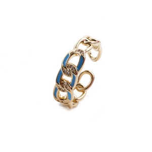 Détail de la bague chaîne dorée avec émail bleu et petits cristaux blancs étincelants