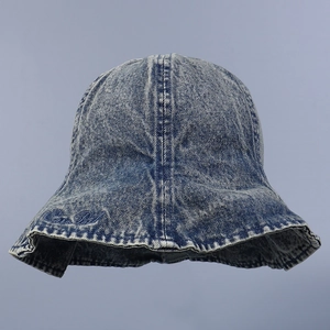 Détail d'un chapeau bob en jean délavé avec broderie élégante et bordure à volants