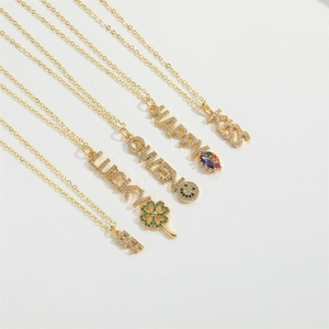 Detail of gold letter necklaces featuring KISS, HAPPY, and LUCKY with colorful zircons