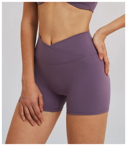 Detail of high-waist yoga shorts showing the V-shaped cross waistband in smoky purple