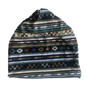 Detailed view of bohemian paisley patterned fabric on a multifunctional slouchy beanie hat
