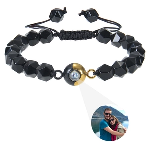 Detailed view of black faceted stone bracelet with adjustable braided rope and photo projection