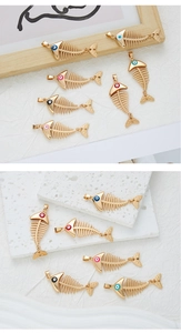 Detail of colorful enamel fishbone pendants with gold plating for DIY jewelry making