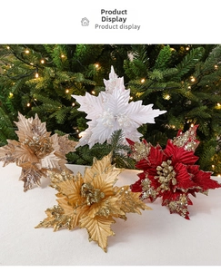 Detail of glittered Christmas poinsettia flowers in red and gold on velvet background