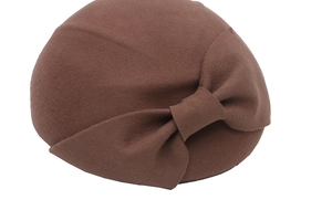 Macro shot of brown wool felt beret with a large decorative bow and soft texture