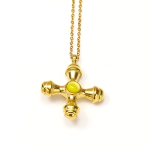 Vintage gold cross pendant necklace featuring a central green gemstone in a retro style