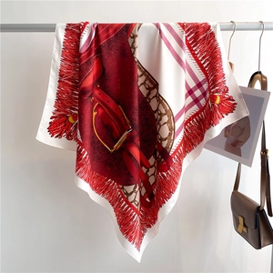 Detailed macro view of the luxury silk scarf with elegant red equestrian harness patterns