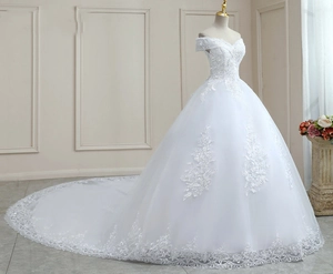 Close-up of elegant off-shoulder wedding dress with floral lace and a long cathedral train