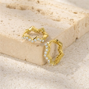 Macro view of gold-plated S925 sterling silver wavy hoop earrings with white zircon