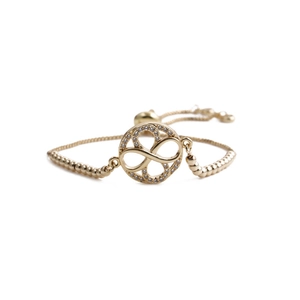 Detailed close-up of golden infinity bracelet with white zircon stones and adjustable chain