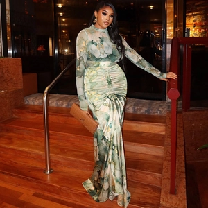Detail of green and yellow marble print on a slim fit maxi dress with ruched waist design