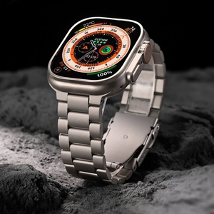 Detailed view of silver titanium alloy watch band on Apple Watch Ultra over rocky ground