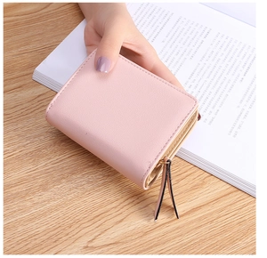 Side view of pink leaf wallet showing tiered accordion structure and gold zipper detail