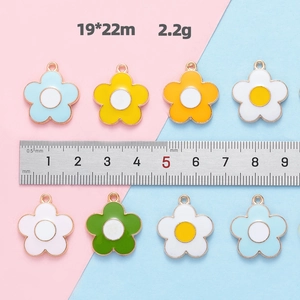 Macro detail of colorful five-petal flower charms with measurement showing 19x22mm size