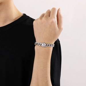 Close-up of 10mm silver Cuban chain necklace with iced-out buckle worn by a male model