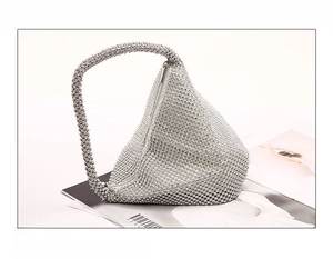 Macro shot of silver rhinestone evening bag with intricate triangle geometric design